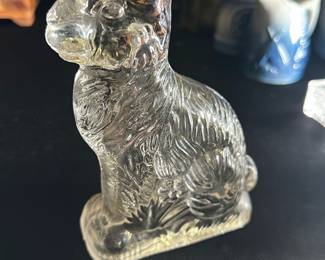 Clear Glass Rabbit Figurine — This charming clear glass rabbit figurine captures fine fur and facial details with elegant craftsmanship. It stands as a decorative piece perfect for home or garden display. The figurine measures approximately 4 inches in height, 2 inches in width, and 1 inch in length. It is in excellent condition without any chips or cracks. A lovely collectible piece suitable for seasonal decor or year-round appreciation.