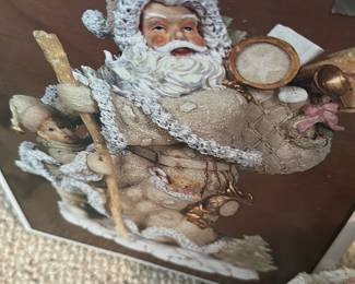 Cedar Creek Holiday Santa Figurine — Cedar Creek Collection holiday Santa figurine in a cream/ivory finish with textured flocking and painted face. The figure carries a sack of toys and staff and includes detailed accents like tiny teddy and drum; boxed with original Cedar Creek Collection holiday box. Measures approximately 12 inches tall by 6 inches wide and 6 inches deep, a good tabletop holiday decor size. Overall good condition with light surface wear to flocking and some cardboard wear to the original box; no major chips or breaks visible.