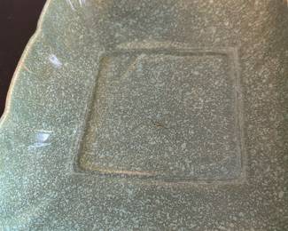Brush USA Green Ceramic Dish 707 — This vintage Brush USA ceramic dish is marked with the model number 707 and features a distinctive green speckled glaze. The square form with gently indented corners highlights mid-century American pottery design. Measuring approximately 8 inches wide, this piece is suitable for decorative or functional use. It is in good condition with some minor surface wear and a small chip on the back as shown in photos. A collectible piece from Brush Pottery, known for its durable and artistic ceramics made in the USA.