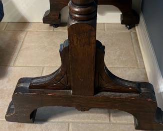 Floor Cheval Tilt Mirror — Freestanding wooden cheval tilt mirror with turned posts and decorative brass tilt keys. Dark stained wood frame with carved pedestal base and original glass, suitable for a bedroom or dressing area. Measures approximately 60 inches tall, 24 inches wide, and 16 inches deep overall; sturdy but shows surface wear and small chips on the base consistent with age. In good, usable condition aside from scuffs and finish loss at feet; brass hardware is intact and functional.