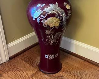 Burgundy Floral Asian Floor Vase — This elegant burgundy floor vase features intricate floral and bird designs in silver and gold tones, showcasing fine Asian-inspired craftsmanship. The tall, slender form with a flared base stands out as a decorative piece suitable for a front room setting. Measuring approximately 28 inches in height and 11 inches in width at the widest point, it is a substantial piece that adds a touch of sophistication. The vase is in good condition with minor surface wear consistent with gentle use. Ideal for accenting home decor or as a statement piece in an entryway or living room.