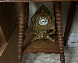 Vintage Oak Accent Table with claw foot — This vintage oak accent table features intricately turned legs and a lower shelf The rich oak finish highlights the wood grain and adds warmth to any bedroom or living room. Measuring approximately 28 in height, 18 in width, and 12 in depth, this compact table offers decorative charm and practical surface space. It is in good condition with minor signs of wear consistent with age and use, and A lovely piece reflecting early 20th-century style and craftsmanship.