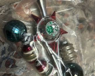 Mid-Century Glass Set — Mid-century style glass Christmas tree topper and matching ornaments in jewel-tone green, red and silver. The set includes a pointed tree topper with starburst motif and faceted green center plus several coordinating bulb and spindle ornaments. Ideal for a vintage-themed holiday display — packed together in a resealable bag and stored indoors. Some surface wear and light scratching consistent with age; vintage glass pieces should be handled carefully.