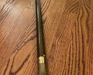 Vintage Brass Handle Cane — This vintage walking cane features a distinctive brass dog head handle, expertly crafted for a unique and elegant look. The shaft is made of dark wood, exhibiting a smooth finish and slight patina indicative of age. Measuring approximately 36 inches in length, it balances both form and function for comfortable use. The condition is good with minor surface wear consistent with vintage items and no structural damage. This cane is a collectible piece with classic design appeal for enthusiasts of vintage accessories.