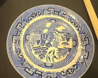 Buffalo Pottery Blue Willow bowl — This vintage Buffalo Pottery plate features the classic Blue Willow pattern in vibrant blue on a semivitreous ceramic base, dated 1941. The plate showcases intricate scenic designs with traditional border motifs characteristic of the Blue Willow style. Measuring approximately 10 inches in diameter, it is a fine example of early 20th-century American pottery. The plate is in good vintage condition with minor wear consistent with age and no visible cracks or chips. This collectible piece from Buffalo Pottery offers both historical charm and decorative appeal for collectors or enthusiasts of blue and white china.