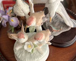 Bird Figurine — This charming set of Lladro porcelain bird figurines features delicately painted birds in natural colors, including three small birds perched on a white floral base and two larger birds on separate bases. Crafted with fine attention to detail, this set showcases the renowned Lladro quality and artistry. The figurines vary in size, with the tallest bird approx. 7 inches high, and the bases roughly 5 inches in diameter, ideal for elegant home display. All pieces are in excellent condition with no visible chips or cracks, maintaining their original lustrous finish. A wonderful collectible set from the respected Spanish maker, perfect for bird lovers and porcelain collectors.
