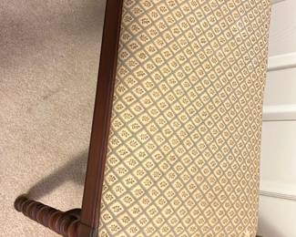 Vintage Upholstered Wooden Bench — This vintage wooden bench features a padded seat upholstered in a cream fabric with a diamond pattern, providing both comfort and classic style. The bench boasts intricately turned legs and a sturdy wooden frame with a warm brown finish, fitting well in bedroom or hallway settings. Measuring approximately 18 inches high, 40 inches wide, and 18 inches deep, it is compact yet practical for seating or decor use. The bench is in good condition with minor wear consistent with age and use, showing no visible damage or repairs. Its traditional design and craftsmanship make it a charming addition to any vintage furniture collection.