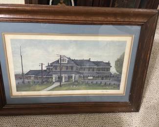 L&N Depot Framed Print — Framed watercolor print titled 'L&N Depot, Crossville, Tennessee' signed by Helen Hayes (visible). The piece is double-matted in blue and cream with a wide wood frame showing surface wear and small nicks; glass appears intact. Overall framed size estimated for wall display; suitable for home or office railroad or local Tennessee decor. Condition is good for display with cosmetic wear to frame and slight mat discoloration consistent with age.
