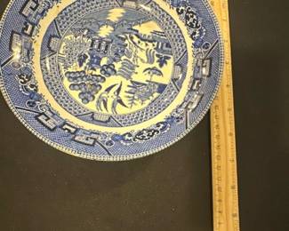 Buffalo Pottery Blue Willow bowl — This vintage Buffalo Pottery plate features the classic Blue Willow pattern in vibrant blue on a semivitreous ceramic base, dated 1941. The plate showcases intricate scenic designs with traditional border motifs characteristic of the Blue Willow style. Measuring approximately 10 inches in diameter, it is a fine example of early 20th-century American pottery. The plate is in good vintage condition with minor wear consistent with age and no visible cracks or chips. This collectible piece from Buffalo Pottery offers both historical charm and decorative appeal for collectors or enthusiasts of blue and white china.