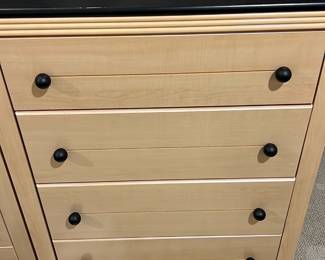 Maple Modern 4-Drawer Chest — This modern four-drawer chest features a smooth maple finish with contrasting black knobs and a flat black top. The clean lines and simple design make it a versatile storage solution for any bedroom or office space. Measuring approximately 36 inches tall, 30 inches wide, and 18 inches deep, it offers ample storage capacity without overwhelming a room. The chest is in good condition with minor surface wear consistent with regular use. Its lightweight construction makes it easy to move and reposition as needed.