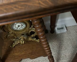 Vintage Oak Accent Table with claw foot — This vintage oak accent table features intricately turned legs and a lower shelf The rich oak finish highlights the wood grain and adds warmth to any bedroom or living room. Measuring approximately 28 in height, 18 in width, and 12 in depth, this compact table offers decorative charm and practical surface space. It is in good condition with minor signs of wear consistent with age and use, and A lovely piece reflecting early 20th-century style and craftsmanship.