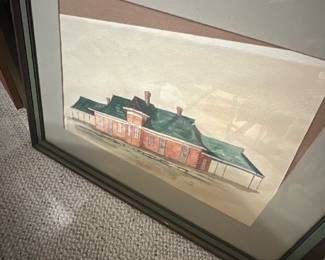 Mason 1976 Framed Watercolor — Framed watercolor architectural study signed "L Mason" dated 1976 depicting a long brick building with green roof. Painted on paper and double-matted in a simple wood frame with glass, the piece shows loose washes and fine line work highlighting doors, chimneys and a covered platform. Overall framed size appears medium and suitable for wall display in a den or hallway; frame and glass remain intact though mats show age spotting. Good estate condition with light surface staining to the lower paper near the signature and typical age wear to the frame.