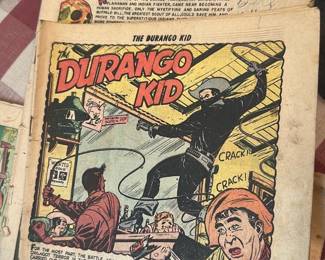 Buffalo Bill & Durango Kid Comics — Lot of 2 Buffalo Bill / Durango Kid comic books photographed in the office up room. Both are pulp-era western comics with full-color covers and interior pages showing age-related foxing, edge wear, and loose binding typical of well-read paper pulps. Combined size is small pocket-comic format (approx. pocket comic dimensions) and suitable for collectors or display with careful handling. Condition is fair with toned pages, torn spine area, and writing on cover noted.