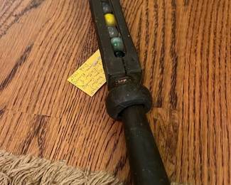 Antique Cane with Built-In Marbles — This antique cane features a unique design with colorful marbles built into the shaft, as noted by the seller. It is crafted from dark wood with a simple handle and shows signs of wear typical for its age. The cane measures approximately 36 inches in length, offering sturdy support combined with a distinctive decorative element. The condition is fair with visible surface wear and patina consistent with long-term use. This walking cane from the front room collection offers both function and collectible appeal.