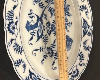 Blue Danube Blue Floral Platter — This Blue Danube platter features a classic blue floral design on white porcelain, showcasing elegant vintage tableware craftsmanship. The platter has a scalloped edge with intricate blue floral motifs both in the center and along the border. Measuring approximately 14 inches in length, it is perfect for serving or display. The piece is in good condition with no visible chips or cracks, displaying slight use consistent with vintage porcelain. Marked with the Blue Danube logo and REG. U.S. PAT. OFF., this platter is a charming addition to any collection or dining set.