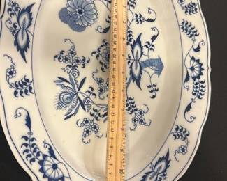 Blue Danube Blue and White Platter — This Blue Danube oval serving platter features an intricate blue floral pattern on crisp white porcelain, showcasing traditional Asian-inspired design. Measuring approximately 15 inches in length and 12.5 inches in width, this piece is ideal for serving or decorative display. Crafted from fine porcelain, it is marked with the Blue Danube maker's stamp on the bottom. The platter is in good condition with no visible chips or cracks, exhibiting only minor signs of use. Perfect for collectors or those looking to add classic blue and white china to their dining collection.