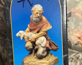 Fontanini Jeremiah Figurine Box — Fontanini Jeremiah from the Fontanini Heirloom Collection (7.5") shown in original retail box printed with 'Fontanini exclusively from Roman, Inc.' The box art shows a kneeling shepherd holding a lamb; box has marker graffiti on front and minor shelf wear. Boxed collectible measures approximately 7.5 inches tall (see dimensions) and is ideal for collectors of Nativity and religious figures. In fair condition due to writing on the box and edge wear; contents not verified — sold as boxed item with visible cosmetic flaws.
