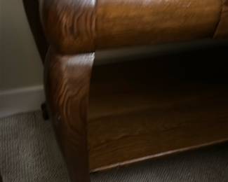 Oak Wood Queen Anne Style Table — This elegant oak wood table features Queen Anne style cabriole legs with claw feet, offering a classic and refined look. The rich wood grain is visible throughout, complemented by a smooth rectangular top and a functional lower shelf for additional storage or display. The piece includes a small drawer with dovetail joints, enhancing both utility and craftsmanship. It measures approximately 24 inches high, 26 inches wide, and 18 inches deep, making it suitable for bedroom or living room use. The table is in good condition with typical light surface wear and minor scratches consistent with age and use.