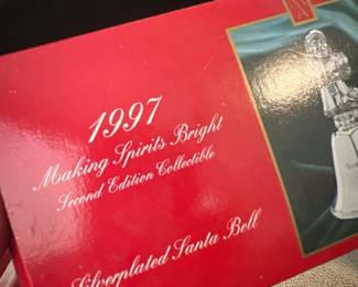 1997 Silverplated Santa Bell — 1997 Making Spirits Bright second edition collectible silverplated Santa bell in original red presentation box. The box shows a photo of the silverplated Santa-top bell and likely contains the bell and paperwork; colors conform to seller note (red box). Boxed holiday collectible ideal for display or seasonal decor. Measurements approximate the boxed item size; condition appears good for sale with some shelf wear to the box visible in photos.