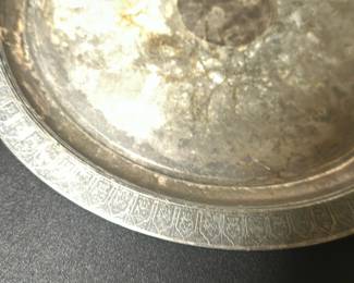 Reed & Barton 10 Silverplate Tray — This vintage Reed & Barton silverplate tray is a classic piece of American craftsmanship. It features an elegant engraved border design and a round shape, measuring 10 inches in diameter. The tray shows typical wear with tarnish and surface scratches consistent with age, reflecting its authentic vintage character. Despite the tarnishing, it remains structurally sound and functional for decorative or serving purposes. Perfect for collectors or those looking to add a timeless silver serving piece to their collection.