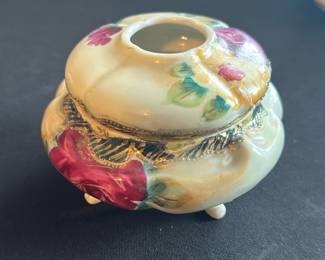 Vintage Floral Porcelain Hair receiver — This vintage floral porcelain anti hair receiver is a charming decorative piece often used in master bedrooms. It features a cream-colored base with hand-painted red, pink, yellow, and green floral designs accented by textured gold trim. The piece measures approximately 3.5 inches in height, 5 inches in width, and 5 inches in length, making it a compact yet elegant addition to any vanity or dresser. It is in good condition with minor crazing and surface wear consistent with age. The receiver bears a red maker's mark on its underside indicative of traditional porcelain craftsmanship.