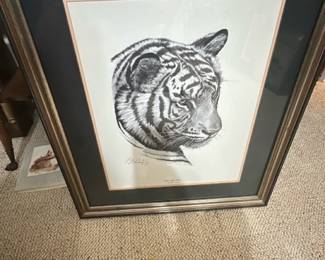 Regency House Art Inc Tiger Print — Regency House Art Inc. framed tiger lithograph featuring a detailed black-and-white tiger head with double mat and gilt-accented frame. The piece is signed by the artist (appears to read Guy Bohabach) in pencil on the lower margin and is presented under glass in a decorative frame. Overall size is estimated for hanging and the work is ready to display from the Bonus Up Room; frame shows normal surface wear and small scuffs visible in photos. In good condition overall with intact glass and matting; minor frame wear consistent with age and handling.