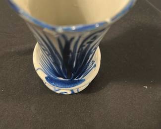 Blue and White Ceramic Vase — This charming blue and white ceramic vase features hand-painted floral designs with elegant lines and decorative patterns. The scalloped top edge and flared form add a distinctive touch to its classic shape, perfect for display or floral arrangements. Measuring approximately 7 inches tall and 3.5 inches wide, it is a lovely accent piece for the blue dishes room or similar decor settings. The vase is in good condition with minor surface wear consistent with gentle use. Its timeless style makes it suitable for both vintage and contemporary collections.