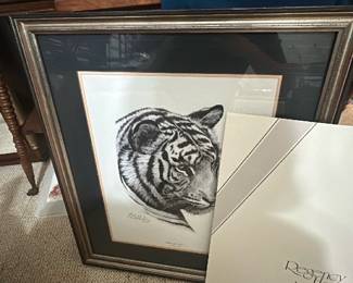 Regency House Art Inc Tiger Print — Regency House Art Inc. framed tiger lithograph featuring a detailed black-and-white tiger head with double mat and gilt-accented frame. The piece is signed by the artist (appears to read Guy Bohabach) in pencil on the lower margin and is presented under glass in a decorative frame. Overall size is estimated for hanging and the work is ready to display from the Bonus Up Room; frame shows normal surface wear and small scuffs visible in photos. In good condition overall with intact glass and matting; minor frame wear consistent with age and handling.