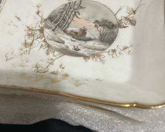 12-CF Thai Porcelain Small Square Dishes — This set of 12 small square porcelain dishes from Thailand features delicate landscape paintings with subtle gold accents around the scalloped edges. Each dish measures approximately 5.5 in by 5.5 in, ideal for serving small items or decorative display. The white porcelain is complemented by fine, hand-painted scenic details and light gold foliage. These dishes are in good condition with minor signs of age or use, perfect for collectors or elegant tabletop settings. The craftsmanship reflects traditional Thai porcelain art, making them unique collectible pieces.
