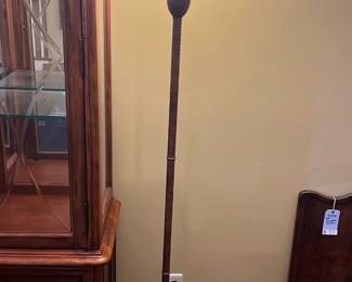 Brown Pineapple Torchiere Floor Lamp — This distinctive pineapple-themed torchiere floor lamp features a textured brown base and post, topped with a wide opaque glass shade that diffuses light warmly. The lamp's height and slim design make it suitable as an accent piece in a dining room or living space. Measuring approximately 65 inches tall and 15 inches wide at the shade, it offers ambient lighting with a classic decorative appeal. It is in good condition with minor surface wear consistent with regular use but no visible damage. Its traditional style and unique pineapple motif make it a charming addition to home decor collections.