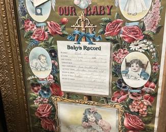 God Bless Our Baby Framed Record — Charming framed "God Bless Our Baby" baby record with colorful Victorian-style illustrations and floral borders. The piece features a printed baby's record center with spaces filled in by hand and is set in an ornate gold-toned molded frame. Frame measures approximately 24 inches high by 18 inches wide and is a lightweight decorative piece suitable for nursery or wall display. Condition is good for age with light wear to frame gilt and minor foxing/toning to the paper; glass appears intact.
