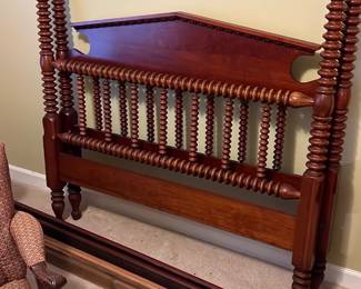 Davis Cabinet Full Size Bed Cherry — This Davis Cabinet full size bed frame in cherry wood features distinctive turned spindles and a rich warm finish, making it a classic addition to any bedroom. The headboard showcases elegant spindle detailing and a gently curved top rail, crafted from solid cherry. Suitable for a full size mattress, the bed measures approximately 54 inches wide by 80 inches long, with a headboard height of about 56 inches. This bed is in good vintage condition with some minor wear consistent with age. Its traditional design and quality craftsmanship make it a timeless piece.