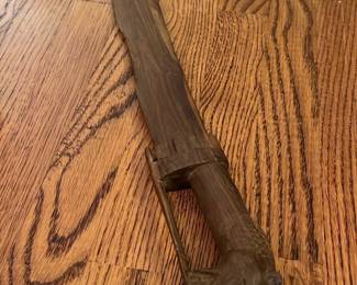 Carved Wooden Decorative Sword — This carved wooden decorative sword features intricate craftsmanship with a detailed handle shaped like an animal head. Made entirely of wood, the sword showcases beautifully carved textures along the blade and handle. Measuring approximately 28 inches in length, it serves as a unique artistic piece suitable for home decor or display. The item is in good condition with some wear consistent with its age and material. Its rustic style makes it a distinctive addition to vintage or eclectic collections.