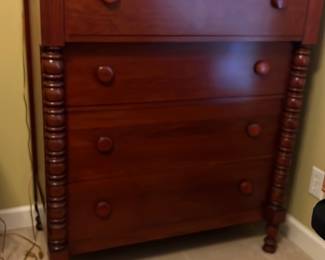 Davis Cabinet Cherry 4-Drawer Chest — This Davis Cabinet cherry 4-drawer chest offers classic bedroom storage with a warm cherry finish. Featuring four spacious drawers with round wooden knobs and detailed turned legs, it brings both elegance and functionality to your bedroom. Designed for bedroom use, it fits neatly within the room's layout, providing ample storage space. The chest is in good condition with minor wear consistent with normal use. Its traditional style and quality woodworking make it a dependable and attractive furniture piece.