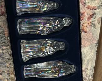 Glass Nativity Figurine Set — Clear crystal nativity figurine set presented in a navy blue velvet-lined box, featuring six molded glass pieces including the Magi and a manger figure. Each piece is clear lead-style crystal with a subtle iridescent finish and molded details; box retains original sticker. Overall good estate condition with light shelf wear to box and no visible chips or cracks on the glass figures. Compact boxed set is ideal for holiday tabletop display or seasonal decor and is easy to pack and transport.