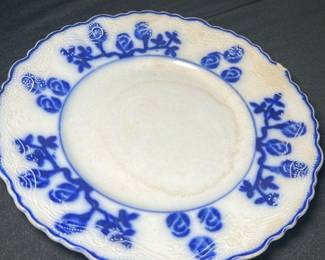 W.A.adams England blue lunch plate — This Wood & Sons Flow Blue plate from England features a beautiful deep blue floral design around a scalloped edge on white porcelain. The plate measures approximately 9 3/8 inches in diameter and shows fine crazing consistent with age, adding vintage charm. It is a classic example of Flow Blue transferware, a collectible style popular in the late 19th and early 20th centuries. The plate is in good condition with no visible chips or cracks, perfect for display or light use. A true piece of English ceramic heritage with a distinctive blue-on-white pattern.