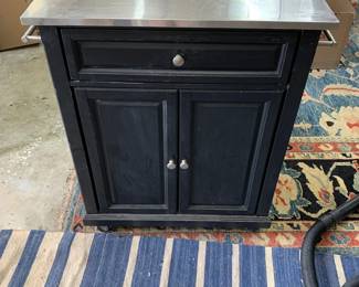#202	blue cabinet with ss counter top 1 drawer and 2 doors on wheels 28x18x35	 $60.00 