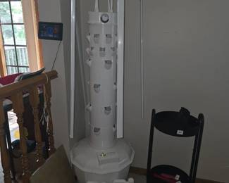 Tower Garden Home or Tower Garden Flex aeroponic growing system, designed for vertical indoor or outdoor farming.
