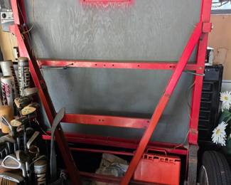 Haul-Master folding utility trailer, commonly sold at Harbor Freight, featuring a red steel frame and plywood decking
