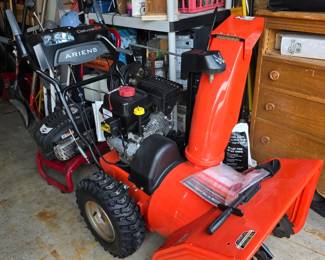           This is an Ariens Deluxe 24 two-stage snow blower featuring a distinctive bright orange chute.It is powered by a 208cc Ariens AX engine designed for heavy snow removal.