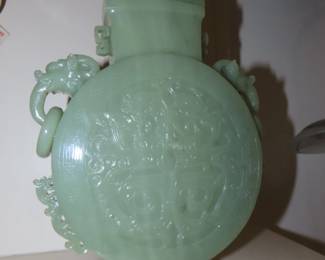 Light green jade, Chinese Hu vase with carved foo dog lid and carved ring handles.