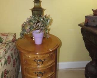 One of two matching end tables with four drawers.