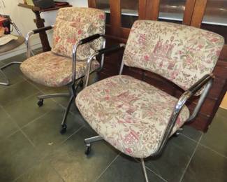 Two matching rolling chrome chairs.