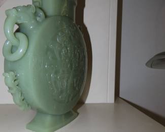 Light green jade, Chinese Hu vase with carved foo dog lid and carved ring handles.