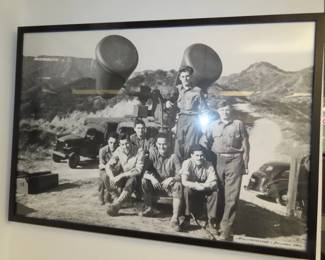 Military personnel standing with a jeep and a searchlight in the Hollywoodland Hills. Likely World war II era.