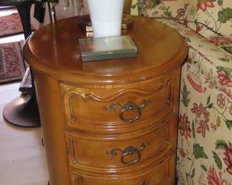 One of two matching end tables with four drawers.