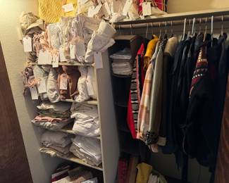 Packed linen closet with bedding, tablecloths pillowcases this closet also houses all the really great coats that this wonderful woman had a lot of them southwestern influence hand beaded. There are two leather fringe coats.