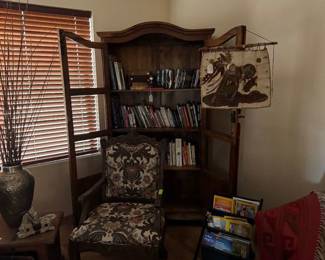 Wonderful two door Mexican Bookcase with shelving filled with Books in Front Mexican hand carved chair upholstered