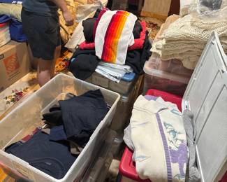 Lots of clothing in bedroom, will be placed on hangers and racks by time of sale