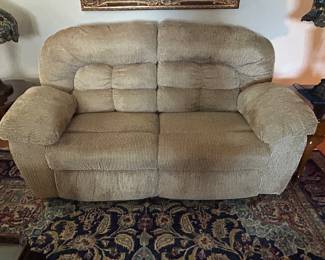Rocking reclining loveseat with storage.